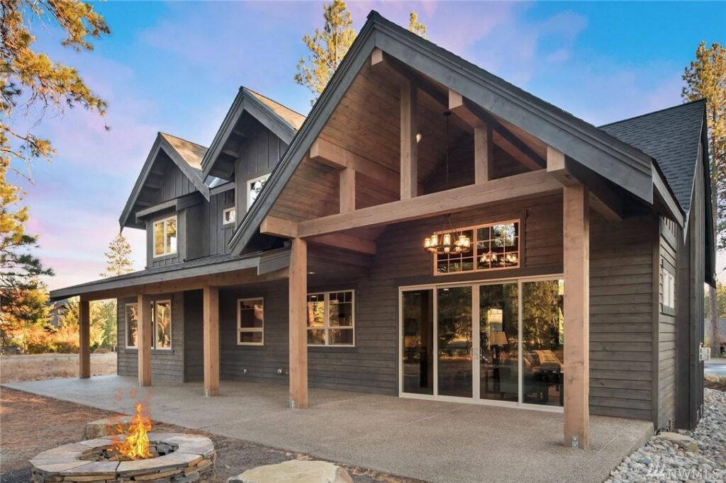 a house with a fire pit in front of it.