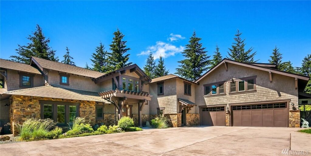 a large house with lots of trees in the background.