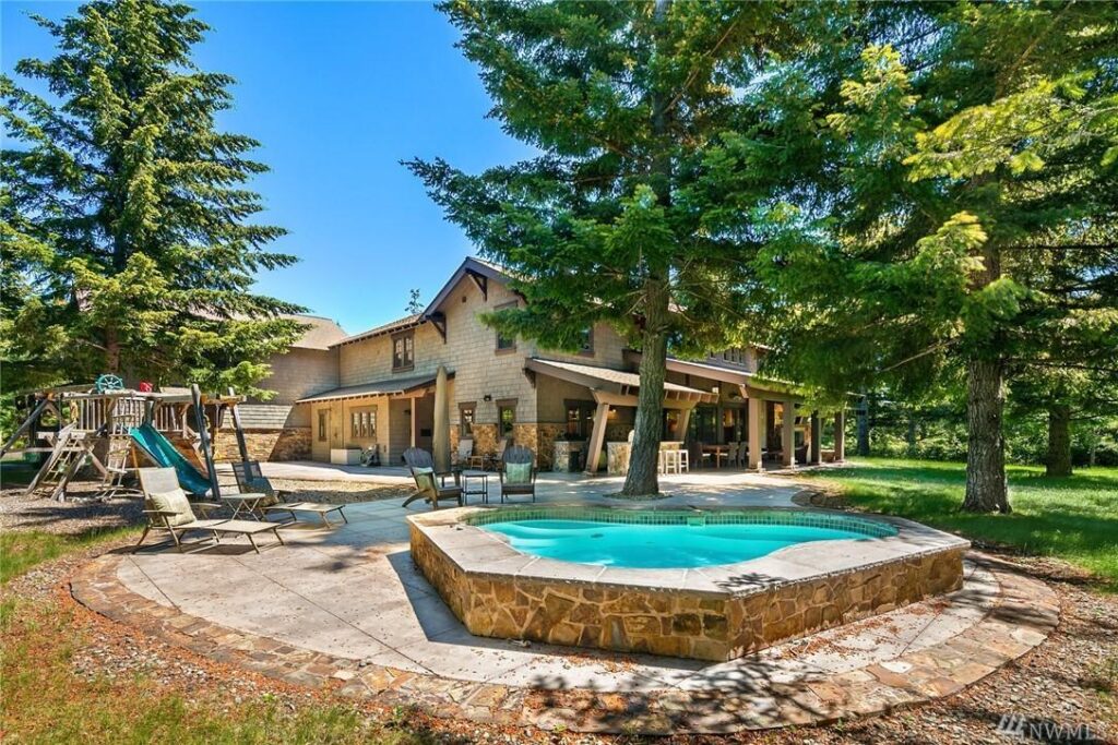 a backyard with a pool and a hot tub.