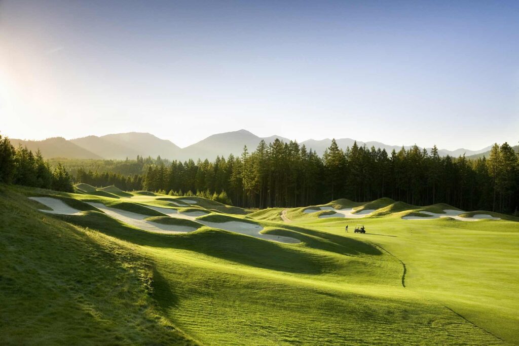 a view of a golf course in the mountains.