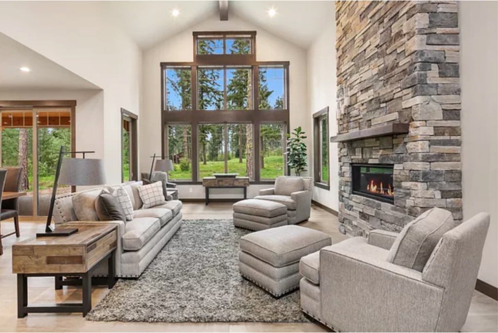 a living room filled with furniture and a fire place.