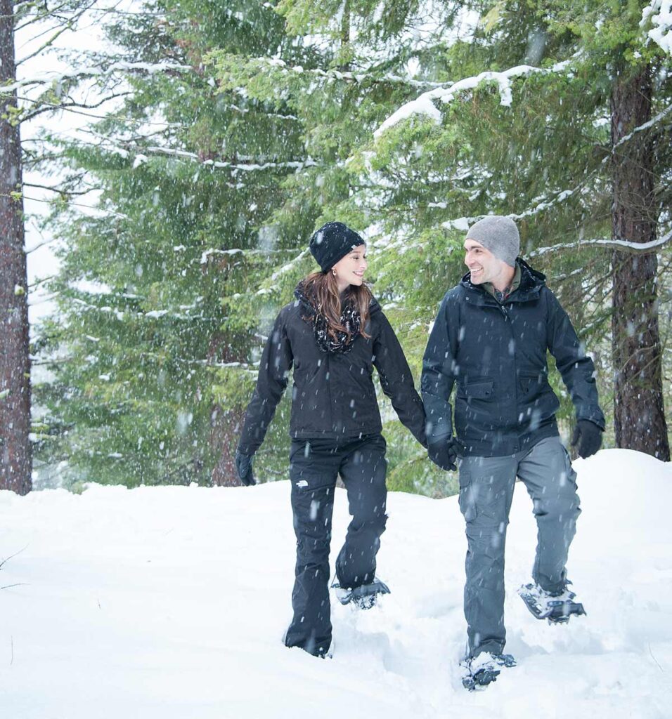 a man and a woman walking in the snow.