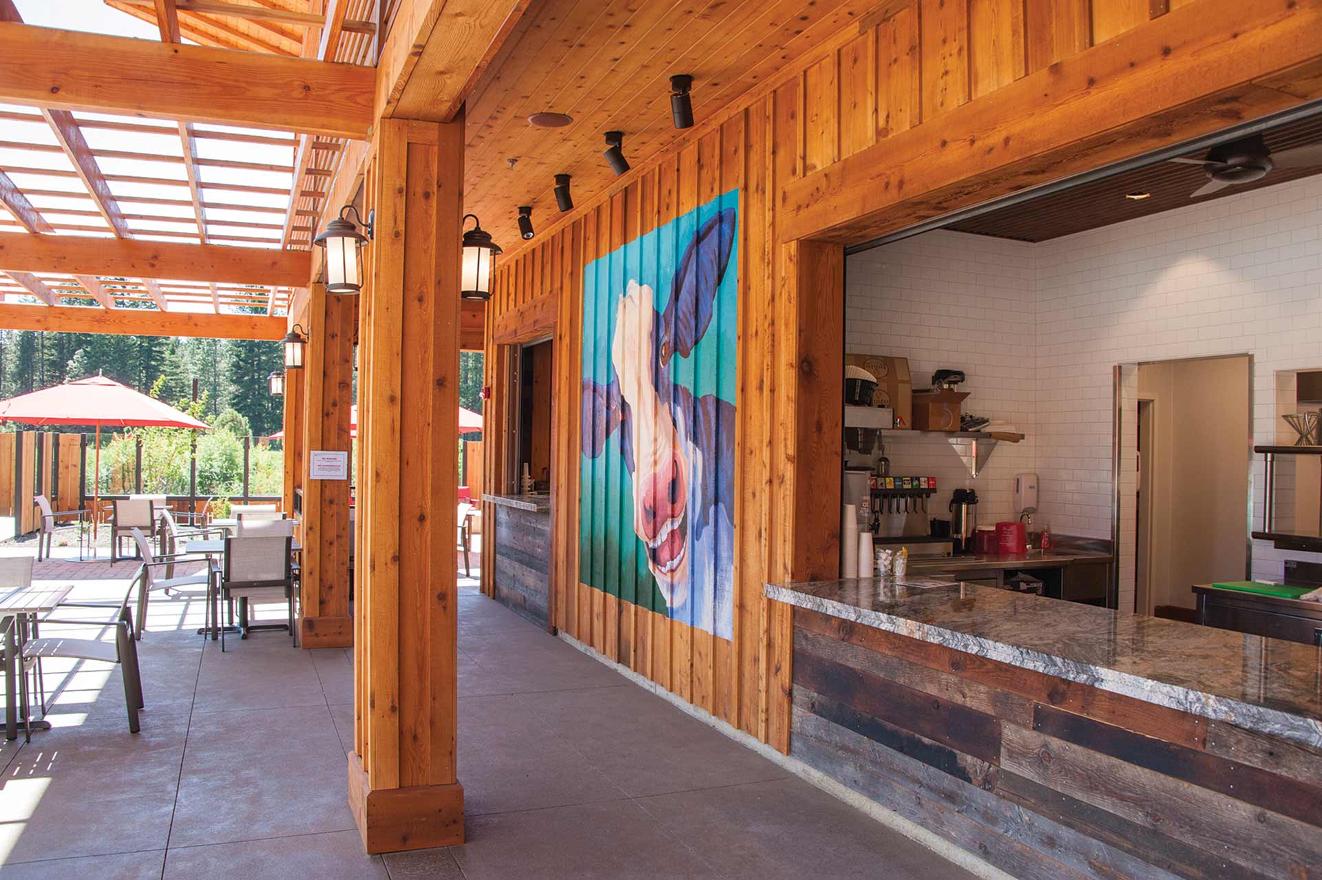 a covered patio with a painting on the wall.
