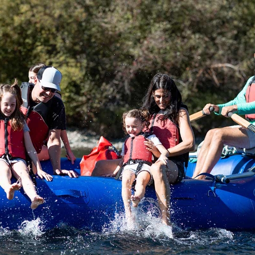 a group of people riding on the back of a raft.